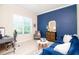 Comfortable living room with a blue accent wall, plush seating, and natural light at 11125 Winthrop Lake Dr, Riverview, FL 33578