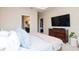 Spacious main bedroom with dresser and television, and an en-suite bath at 11125 Winthrop Lake Dr, Riverview, FL 33578