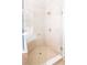 Contemporary tiled shower with glass door enclosure, built in bench and modern shower head at 11125 Winthrop Lake Dr, Riverview, FL 33578