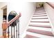 Staircase features wood and white risers and ornamental wood and iron banister at 11125 Winthrop Lake Dr, Riverview, FL 33578
