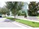 A light green two-story home with white picket fence and lush landscaping at 11125 Winthrop Lake Dr, Riverview, FL 33578