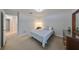 Bedroom features neutral carpet, a ceiling fan, and a window with natural light at 12127 Luftburrow Ln, Hudson, FL 34669