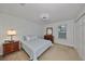 Cozy bedroom featuring neutral carpet, a ceiling fan, and a window with natural light at 12127 Luftburrow Ln, Hudson, FL 34669