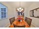 Cozy dining room featuring a wood table with seating for six and views of the kitchen at 12127 Luftburrow Ln, Hudson, FL 34669