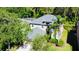 Aerial view of a beautiful two-story home surrounded by mature trees and well-maintained landscaping at 12127 Luftburrow Ln, Hudson, FL 34669