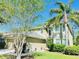 Charming two-story home featuring lush landscaping and a well-maintained lawn at 12127 Luftburrow Ln, Hudson, FL 34669
