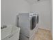 Laundry room featuring a utility sink, washer, and dryer with tiled floors at 12127 Luftburrow Ln, Hudson, FL 34669