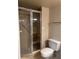 Bathroom showcasing a glass-enclosed shower, toilet, and neutral color scheme at 2333 Feather Sound Dr # B301, Clearwater, FL 33762