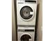 An electrolux stacked washer and dryer set in a compact laundry area for convenience at 2333 Feather Sound Dr # B301, Clearwater, FL 33762