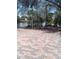 Brick backyard patio overlooking water and trees at 4228 Spring Way Cir, Valrico, FL 33596
