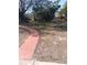 View of the backyard with a path leading toward the trees and a pond at 4228 Spring Way Cir, Valrico, FL 33596