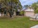 Charming single-story home with stone accents, a two-car garage, and well-maintained lawn at 4228 Spring Way Cir, Valrico, FL 33596