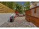 Backyard seating area with brick pavers and tropical landscaping, perfect for outdoor relaxation and entertaining at 4845 W Sunset Blvd, Tampa, FL 33629
