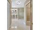 Bright bathroom featuring dual pedestal sinks, a large walk-in shower and tile flooring at 4845 W Sunset Blvd, Tampa, FL 33629