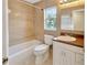 Bathroom with a single sink vanity, bathtub and shower combination at 4845 W Sunset Blvd, Tampa, FL 33629