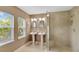 Bathroom with double sinks, a walk-in shower and a large window that provides natural light at 4845 W Sunset Blvd, Tampa, FL 33629