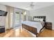 Comfortable bedroom with a ceiling fan and doors that leads to the exterior at 4845 W Sunset Blvd, Tampa, FL 33629