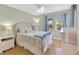 Bedroom with hardwood floors, a ceiling fan, a pair of windows and neutral colored walls at 4845 W Sunset Blvd, Tampa, FL 33629