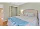 Bright bedroom featuring a patterned comforter set and a closet with bi-fold doors at 4845 W Sunset Blvd, Tampa, FL 33629