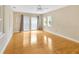 An airy room features hardwood floors, multiple windows, and natural light at 4845 W Sunset Blvd, Tampa, FL 33629