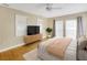 This bedroom features hardwood floors, a large window, and ample natural light at 4845 W Sunset Blvd, Tampa, FL 33629