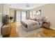 Bright bedroom featuring a ceiling fan, wood flooring, neutral walls, and direct patio access at 4845 W Sunset Blvd, Tampa, FL 33629