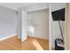 A closet with shelving, hardwood floors, and a TV mounted on the wall at 4845 W Sunset Blvd, Tampa, FL 33629