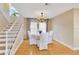 Elegant dining room with hardwood floors, chandelier lighting, and staircase creating a welcoming ambiance at 4845 W Sunset Blvd, Tampa, FL 33629