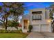Beautiful home with manicured lawn, two car garage, and modern architectural details at 4845 W Sunset Blvd, Tampa, FL 33629