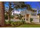 Stunning home featuring a stucco facade, mature landscaping, and charming front porch at 4845 W Sunset Blvd, Tampa, FL 33629