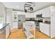 White cabinets, stainless steel appliances and granite countertops in this fully renovated kitchen with tile floors at 4845 W Sunset Blvd, Tampa, FL 33629