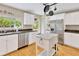 Bright kitchen with stainless steel appliances, white cabinets, and a center island, perfect for cooking at 4845 W Sunset Blvd, Tampa, FL 33629