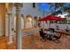 Charming patio area with brick flooring, outdoor seating, and white pillars, perfect for entertaining at 4845 W Sunset Blvd, Tampa, FL 33629
