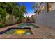 Backyard pool with brick pavers and tropical landscaping, perfect for outdoor relaxation and entertaining at 4845 W Sunset Blvd, Tampa, FL 33629