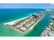 Stunning aerial view of beachfront condos on Treasure Island with boat docks and beach access at 7537 Bayshore Dr # 406, Treasure Island, FL 33706
