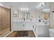 Bathroom with double sinks, white cabinetry, and a glass shower enclosure at 7537 Bayshore Dr # 406, Treasure Island, FL 33706