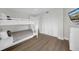 This bedroom boasts ample storage space with a built-in closet and bunk beds for guests or Gathering at 7537 Bayshore Dr # 406, Treasure Island, FL 33706