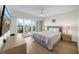 Bright bedroom with sliding glass doors to a private balcony overlooking the water at 7537 Bayshore Dr # 406, Treasure Island, FL 33706
