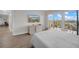 Beautiful bedroom with a balcony overlooking the water, a television, and light wood floors at 7537 Bayshore Dr # 406, Treasure Island, FL 33706
