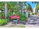 Charming community sign amidst lush greenery, creating an inviting entrance at 7537 Bayshore Dr # 406, Treasure Island, FL 33706