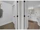 Hallway leads to the bathroom and closet with a white door and wood floors at 7537 Bayshore Dr # 406, Treasure Island, FL 33706