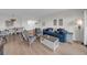 Bright living room with view to dining area offers comfortable seating and a view of the outdoor scenery at 7537 Bayshore Dr # 406, Treasure Island, FL 33706