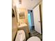 Compact bathroom featuring a vanity, toilet, and a glimpse of a tub/shower combo, with updated vinyl flooring at 8702 Mallard Reserve Dr # 104, Tampa, FL 33614