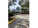 View of the community gate leading to buildings and lush landscaping with palm trees at 8702 Mallard Reserve Dr # 104, Tampa, FL 33614