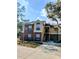 A two-story brick and siding condominium with a peaked roof and several windows at 8702 Mallard Reserve Dr # 104, Tampa, FL 33614
