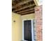 Exterior close up of the unit 104 entrance with a black door and brick and siding facade at 8702 Mallard Reserve Dr # 104, Tampa, FL 33614