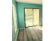 Bright living room with wood-look floors, natural light from large sliding glass doors, and a neutral color palette at 8702 Mallard Reserve Dr # 104, Tampa, FL 33614