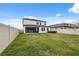 A spacious fenced-in backyard features well-maintained lush grass and a covered outdoor patio space at 14786 Horse Trot Rd, Lithia, FL 33547