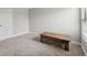 Neutral toned bedroom with a decorative, rustic, American flag themed bench beneath a window at 14786 Horse Trot Rd, Lithia, FL 33547