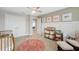 Cozy Bedroom featuring a crib, changing station, and charming decor, creating a welcoming space for baby at 14786 Horse Trot Rd, Lithia, FL 33547
